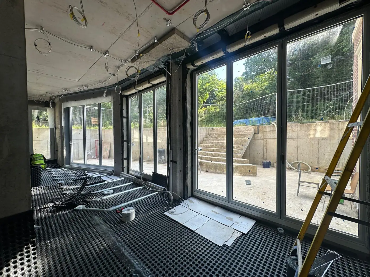 Full-height glazing to board-marked retaining lightwell